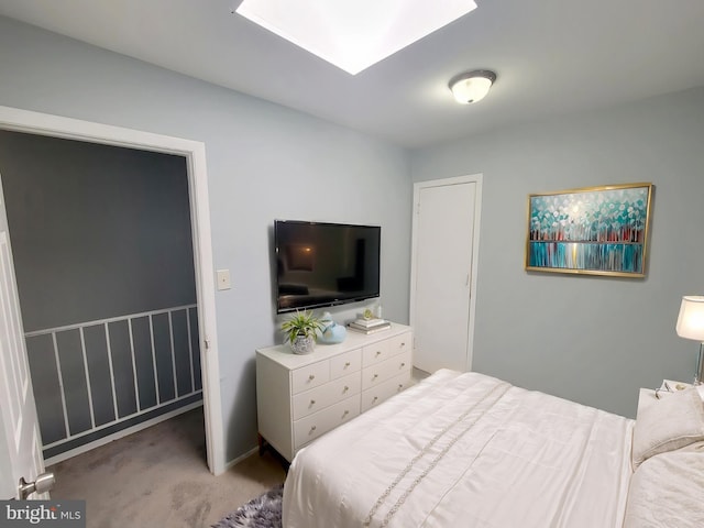 carpeted bedroom with a skylight