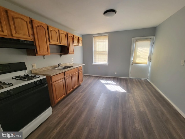 kitchen featuring dark hardwood / wood-style flooring, sink, and range with gas cooktop