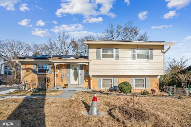 split level home with a front lawn