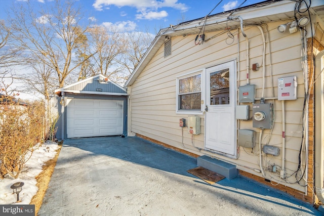 view of side of property with a garage and an outbuilding