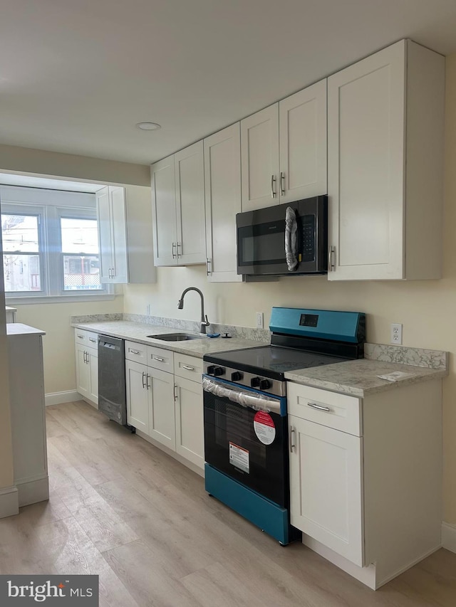 kitchen with sink, stainless steel range with electric cooktop, light hardwood / wood-style flooring, dishwasher, and white cabinets