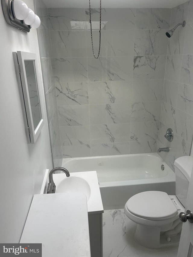 full bathroom with tiled shower / bath combo, vanity, and toilet