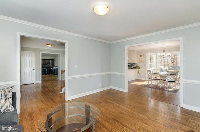 interior space with crown molding, hardwood / wood-style floors, and an inviting chandelier