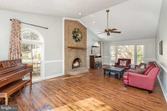 living room with hardwood / wood-style flooring, ceiling fan, a healthy amount of sunlight, and a fireplace