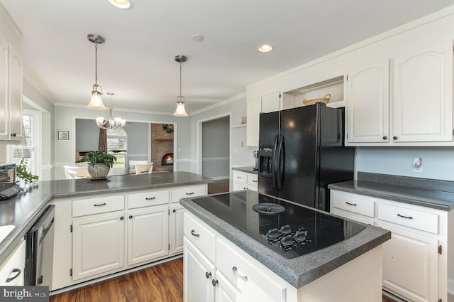 kitchen with white cabinetry, a kitchen island, ornamental molding, and black appliances