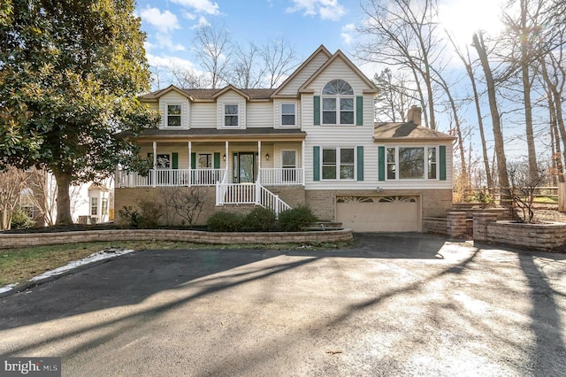 front of property featuring a garage and covered porch