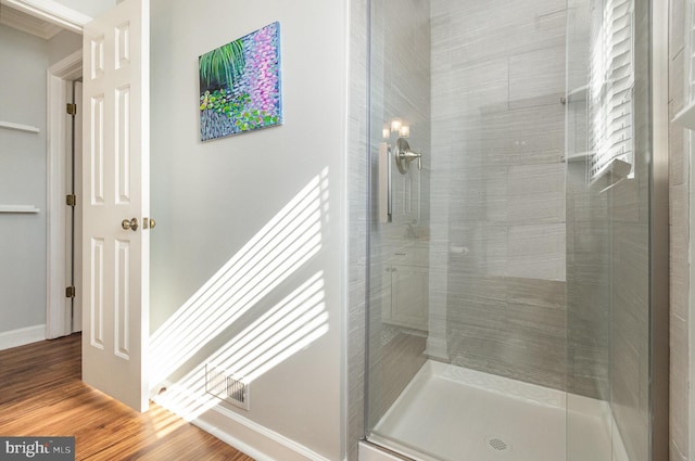 bathroom featuring wood-type flooring and walk in shower