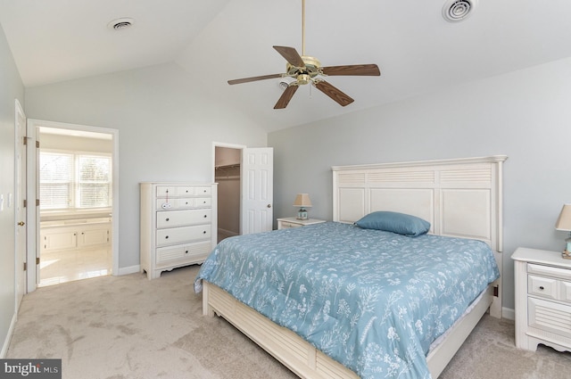 carpeted bedroom featuring vaulted ceiling, a spacious closet, ceiling fan, and a closet