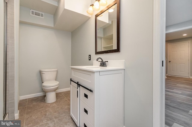 bathroom featuring vanity, toilet, and tile patterned flooring