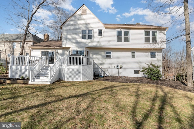 back of house with a yard and a deck