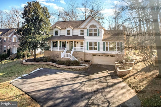 view of front of home featuring a garage and a porch