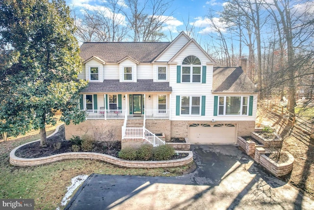 view of front of house featuring a garage and covered porch