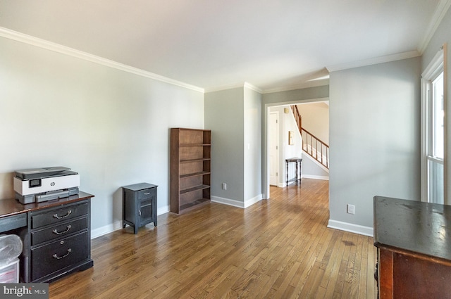 office area with hardwood / wood-style floors and crown molding