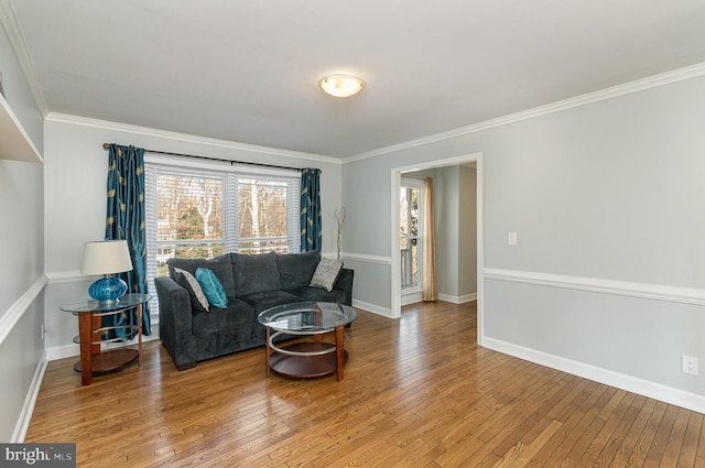 living room with hardwood / wood-style flooring and ornamental molding