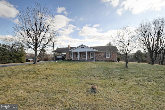 ranch-style home with a front lawn and covered porch