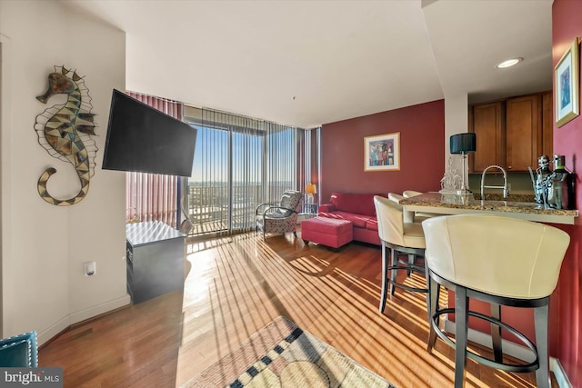 105 Christina Landing Dr Unit 905, Wilmington, DE 19801 - living room with a wall of windows, wood-type flooring, and sink
