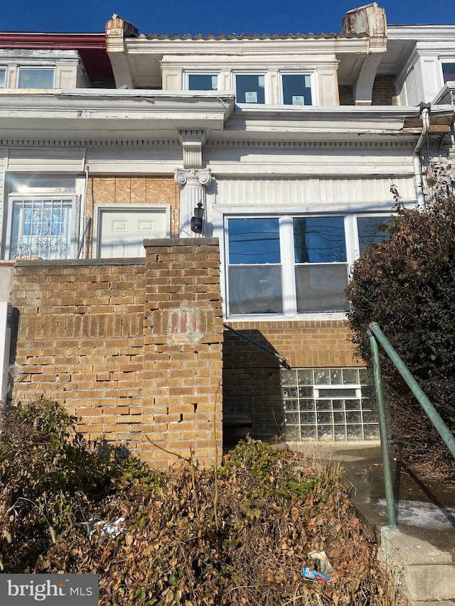 view of side of property featuring brick siding