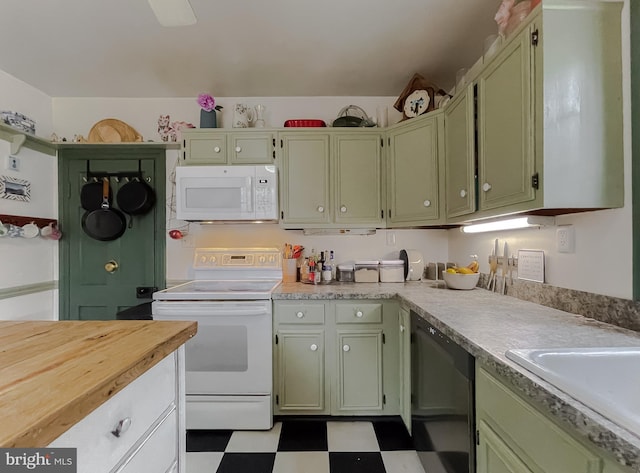 kitchen with white appliances, sink, and green cabinets