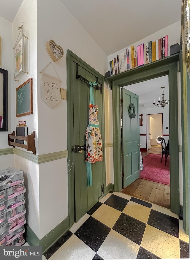 hallway with a notable chandelier