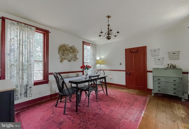 dining area with an inviting chandelier and wood-type flooring