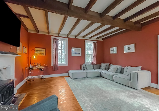 living room with hardwood / wood-style flooring and lofted ceiling with beams