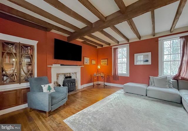 living room featuring beam ceiling and hardwood / wood-style flooring