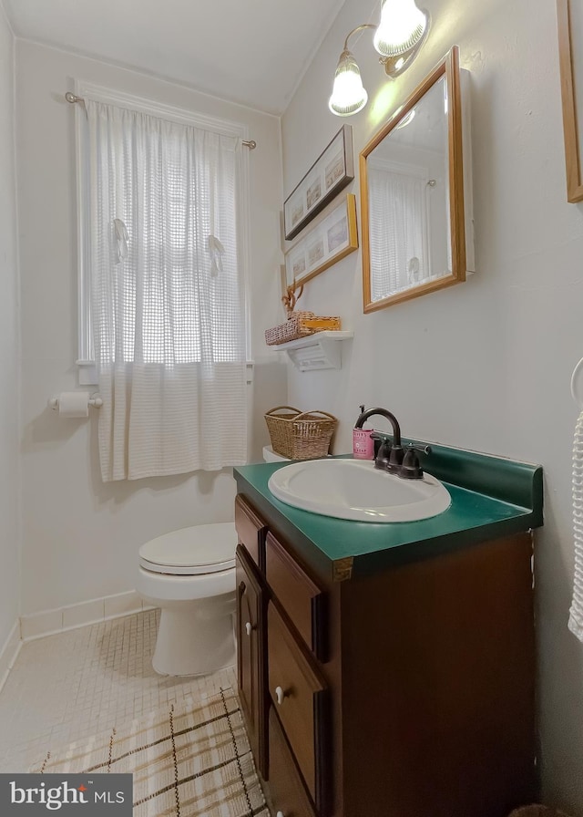 bathroom with vanity, toilet, and tile patterned flooring