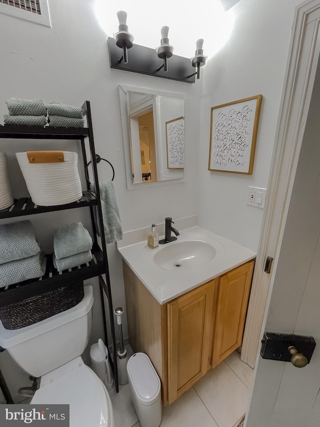 bathroom with tile patterned floors, vanity, and toilet