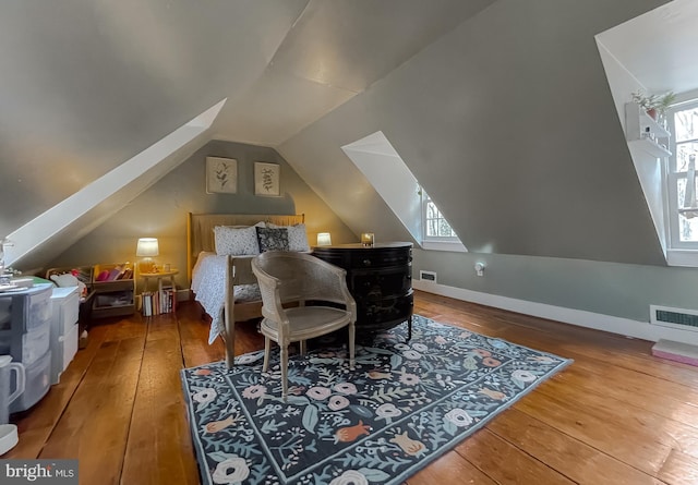 bedroom featuring lofted ceiling and wood-type flooring