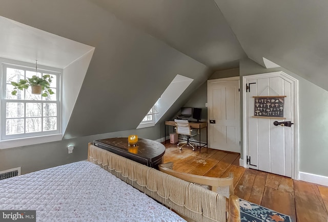 bonus room with wood-type flooring and vaulted ceiling