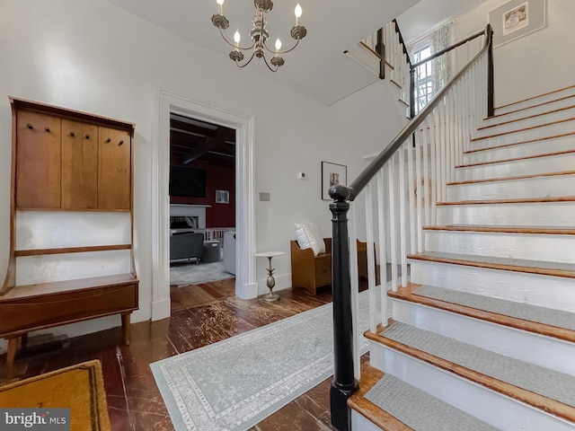 stairway featuring an inviting chandelier and hardwood / wood-style flooring