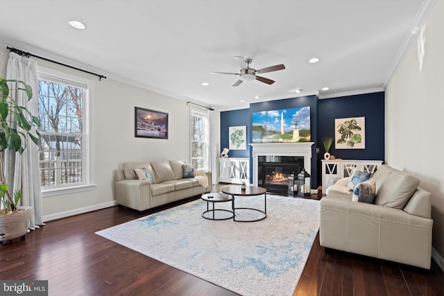 living room featuring crown molding, dark wood-type flooring, and ceiling fan