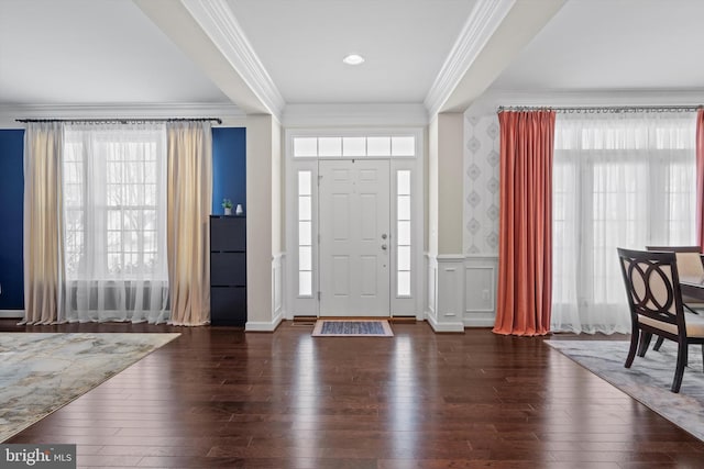 entryway featuring crown molding and dark hardwood / wood-style floors