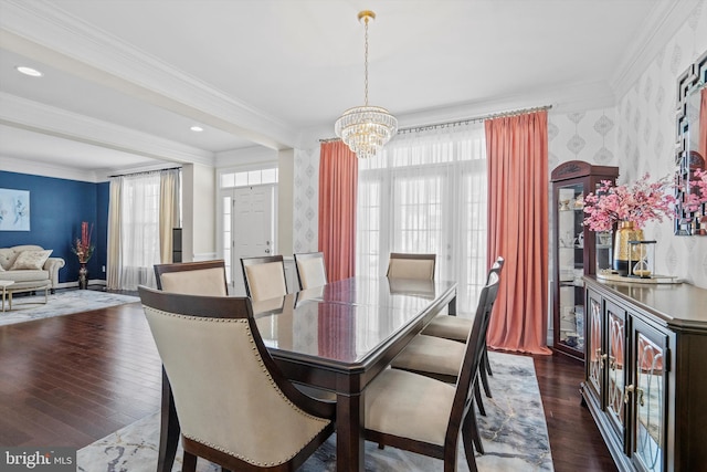 dining space with ornamental molding, dark wood-type flooring, and a notable chandelier