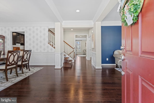 foyer entrance with dark hardwood / wood-style flooring and ornamental molding