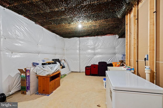 basement featuring sink and refrigerator