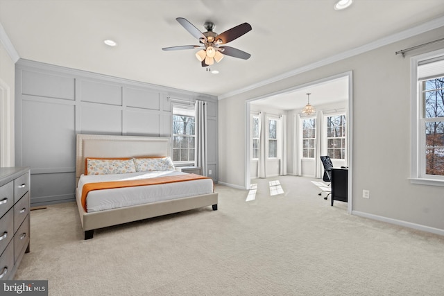 bedroom featuring light carpet, ornamental molding, and ceiling fan