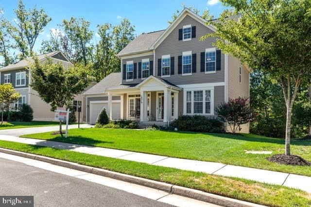 view of front of property with a garage and a front yard