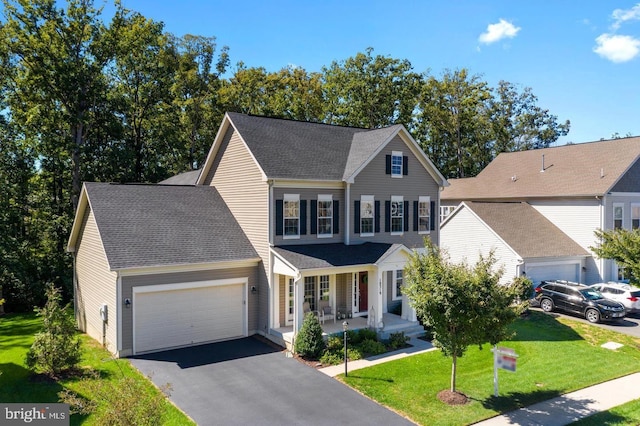 view of front of home with a porch, a garage, and a front lawn