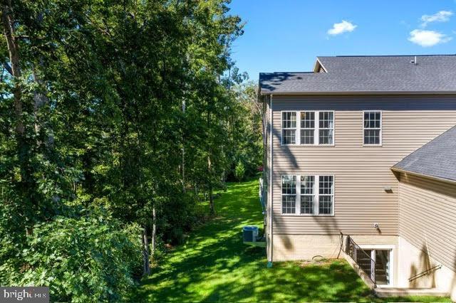 rear view of property featuring a yard