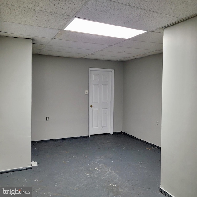 interior space with a paneled ceiling