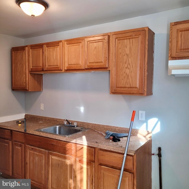 kitchen featuring stone counters and sink