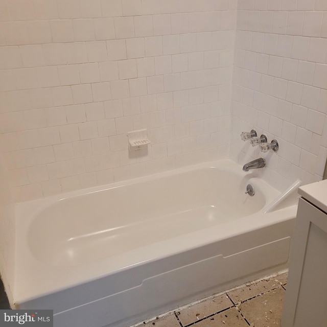 bathroom with tile patterned flooring and a bathtub