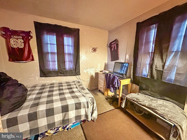 carpeted bedroom featuring crown molding