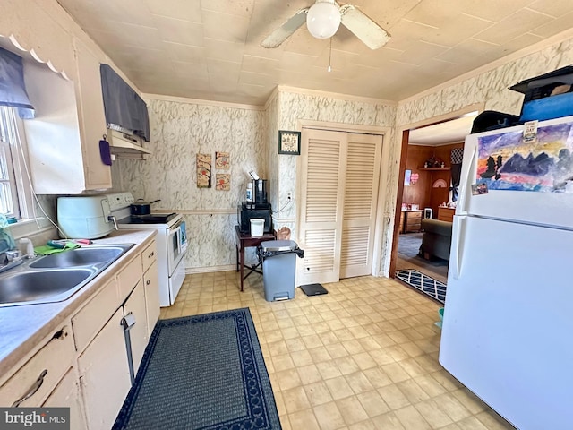 kitchen with sink, white appliances, white cabinets, ceiling fan, and exhaust hood