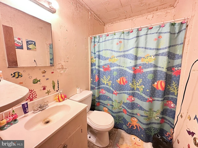 bathroom featuring vanity, toilet, and curtained shower