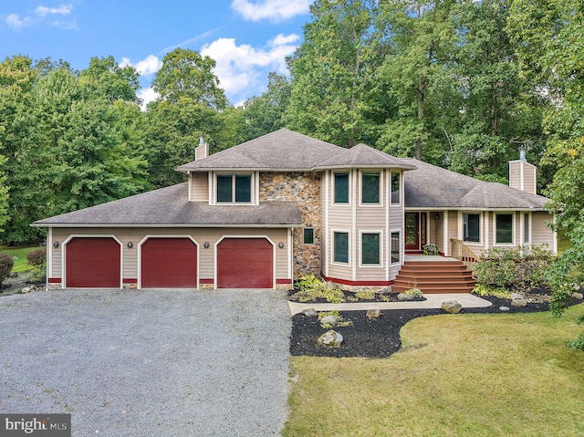 view of front of home with a garage and a front lawn