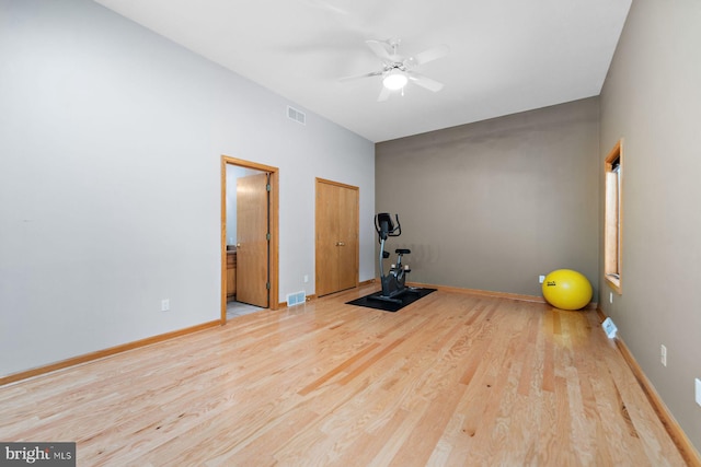 exercise area with light hardwood / wood-style flooring and ceiling fan