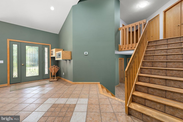 tiled entryway with high vaulted ceiling