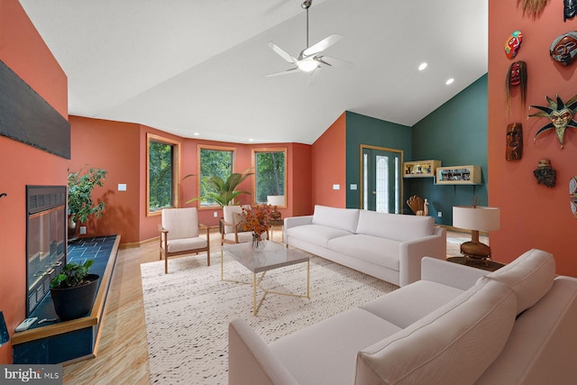 living room with light hardwood / wood-style flooring, high vaulted ceiling, and ceiling fan